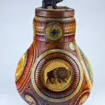 A large vase with a bear on top of it.